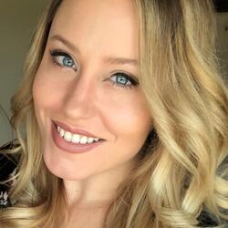 Alex Chrystal, UCR Communications and Training Manager, headshot, woman smiling wearing a necklace and blonde hair