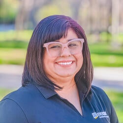 Stella Rocha, Student Academic Specialist at UC Riverside, wearing a black UCR branded polo, smiling 