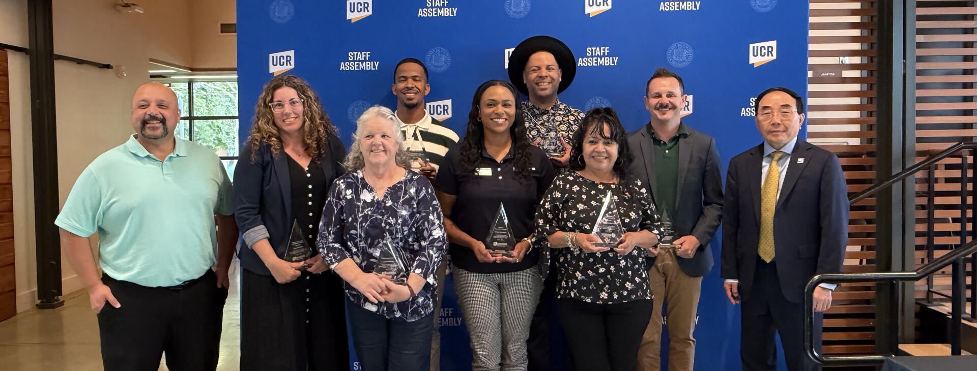 2026 Outstanding Staff Awardees posing with CHRO Alex Najera and Chancellor S. Jack Hu.