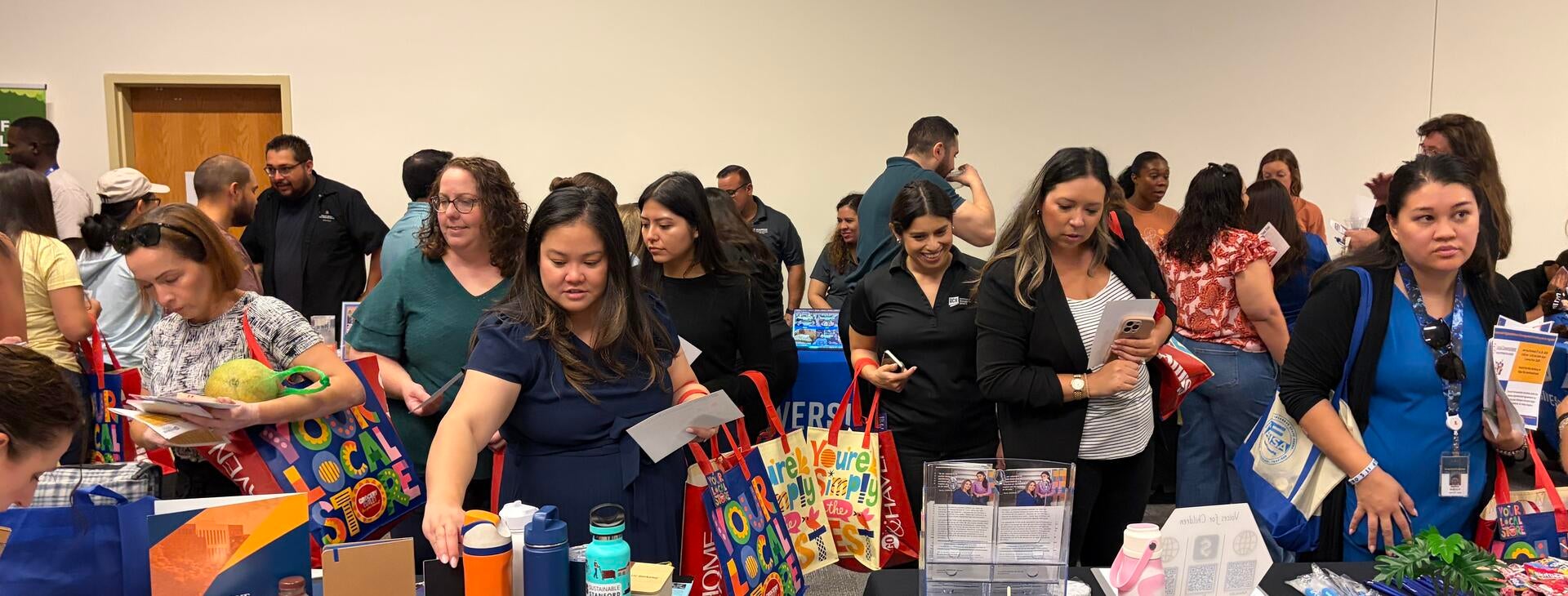 Community Partner Fair attendees visiting vendor booths.